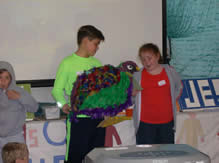 Boy and girl holding a model of a quail