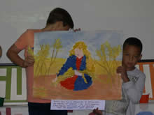 Children holding a picture of Ruth among the corn