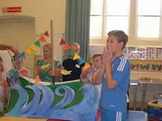 Children with a model of a boat on a stormy sea