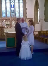 Couple getting married at the altar in St Paul’s with minister and young bridesmaid