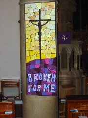 Silhouette of Jesus on the Cross against yellow mosaic background above purplish mosaic ground with words: 'Broken for me'